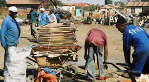 Pikitup workers neatly packing card boxes to be recycled