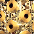Spools of thread on machines in a Cape Town textiles factory
