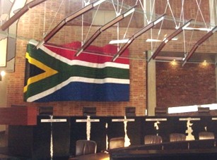 The impressive flag adds colour to the muted tones of the courtroom