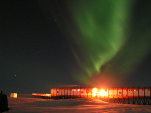 The aurora australis light up the Antarctic sky behind the Sanae IV base