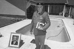 James Gregory with framed photographs of Mandela 