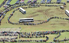 Mourners queue up for a bus ride to view Nelson Mandela's body 